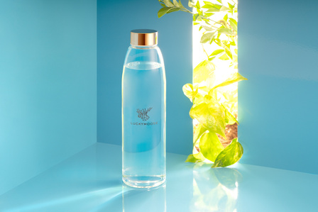 a conceptual blue background with a hint of green nature for branding exercise of a water bottle brand based in germany by top still life photographer based in mumbai india