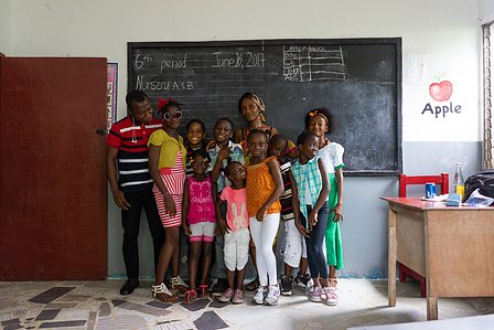 Group shot of people standing in front of a blackboard in a school shot by ashish gurbani top photographer based in mumbai india.