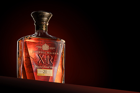 concept photoshoot of Johnnie walker luxury single malt whiskey in mood lighting background with orange glow shot in a studio setting by luxury product photographer Ashish Gurbani based in Pune India