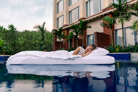 a surreal female model laying in a water bed enjoying a heavenly nap for westin goa campaign photography by top campaign photographer based in mumbai india