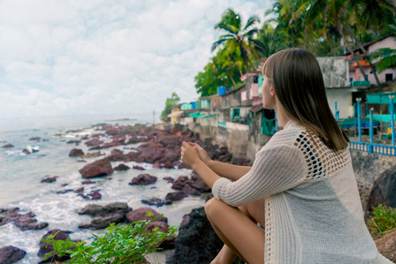 a model enjoying some undiscovered Goan secret views of a valley overlooking the sea photographed by leading fashion photographer based in Mumbai india