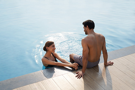 a beautiful young couple poses for Lifestyle photography in mumbai in a swimming pool