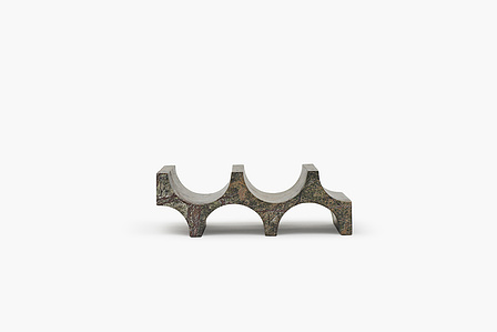 a stone cut bottle shaped rock material stand shot in a studio setup macro photography