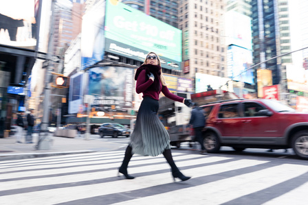 fashion model crossing the street fashionably by Times Square in New York shoot with leading indian fashion photographer based in mumbai india