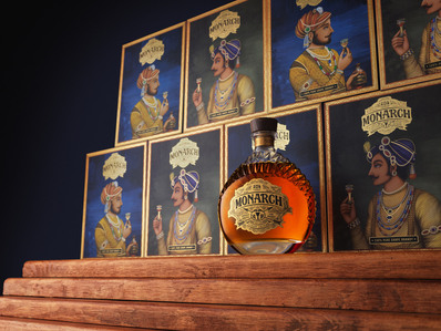 a alcohol bottle placed in front of many boxes  for ad photography with wooden steps in india
