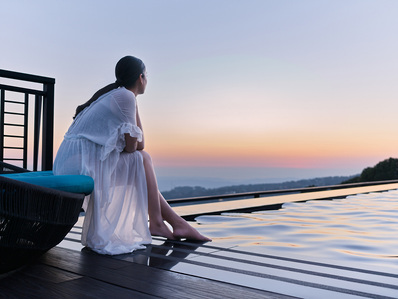 a gorgeous woman photographed by advertising commercial photographer in india by the swimming pool during twilight hour