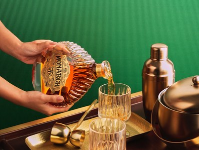 A hand model pours liquid whiskey in lifestyle photography in mumbai for a alcohol beverage brand shoot 