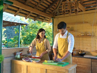 a charming couple cooking a meal for the best hotel photographer Mumbai