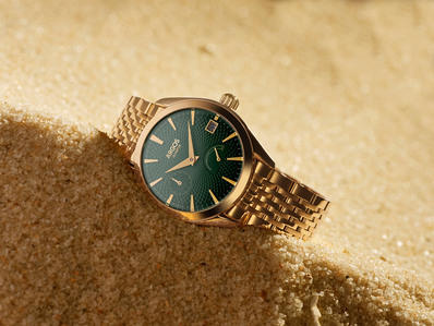 a golden watch dug in sand for a concept shoot by top product photographer in mumbai