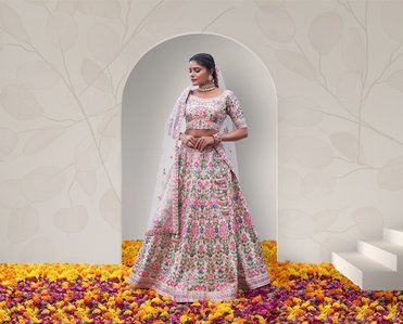 a female model standing in a designer lehenga in front of a textured wall in studio setup shoot by a leading advertising photographer based in Pune india