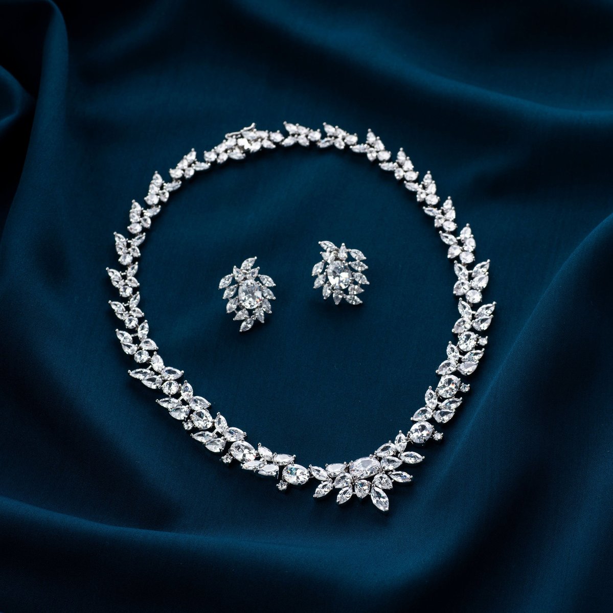 a professional product photoshoot of a solitaire diamond necklace on blue wave cloth concept shoot with top fashion photographer ashish gurbani based in mumbai india