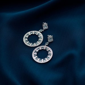 a white gold jewellery earrings concept shoot on blue cloth photoshoot with leading creative jewellery photographer ashish gurbani based in mumbai india
