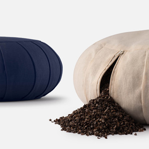 Beautiful yoga cushion opened up with its filling pouring out on a white background studio eCommerce shoot by best luxury product photographer based in Pune India