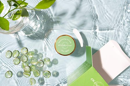 a water splash conceptual photoshoot with green crystals and a water vase placed by indian more creative product photographer based in bangalore india