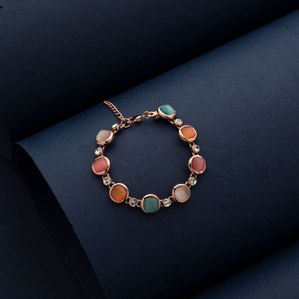 a colourful bracelet complimenting minimal blue background for indian jewellery brand photoshoot taken by top advertising photographer specialising in jewellery photography ashish gurbani based in mumbai india