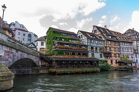 Colorful houses on the edge of a beautiful canal also having an overpass for tourists and people shot by best travel photographer based in Mumbai India.