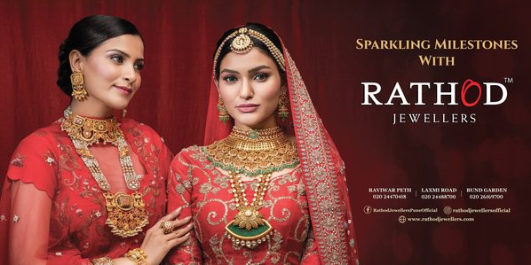modern indian wedding brides wearing beautiful handcrafted gold jewellery posing for a billbaord campaign for brand rathod jewellers by leading jewellery advertising photographer based in pune india
 