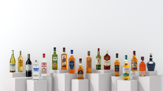 a portfolio of all pernod ricard brands showcasing a variety of whiskey, vokda, gin in a beautiful collection of glass bottles placed on a variety of white boxes for ad photography in india
