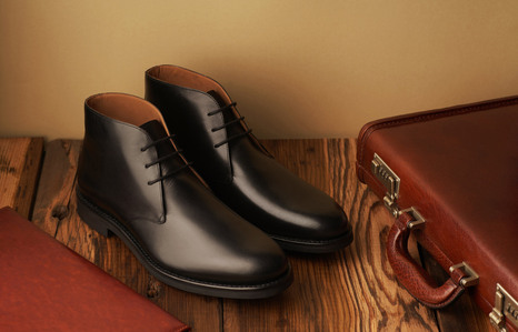 leading footwear brand photographer based in pune shoots black formal leather shoes with brown briefcase on wooden table top