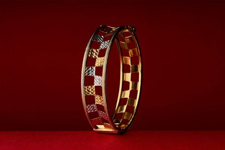 golden bangle shot in a photo studio flash lighting setup for jewellery brand campaign photographed by jewellery photographer based in mumbai india