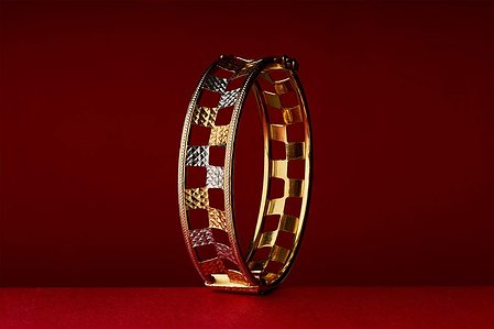 golden bangle shot in a photo studio flash lighting setup for jewellery brand campaign photographed by jewellery photographer based in mumbai india