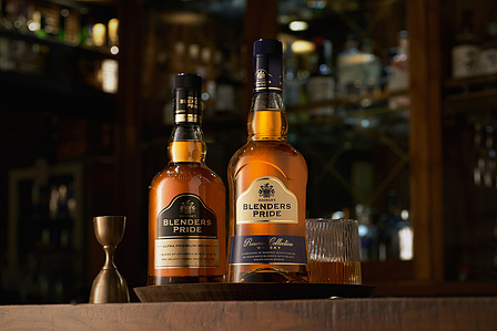 two blenders price bottles placed in a cozy wooden bar setup photographed for the brand campaign photoshoot in mumbai india