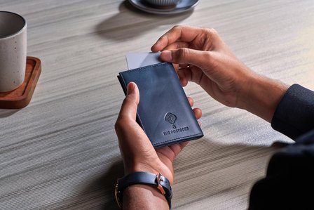 a luxury blue wallet on creative product photography background of table setup at a cafe in mumbai india