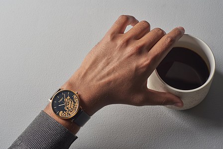 a leading watch photogrphy captures a hand picking coffee mug in mumbai india