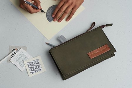 a luxury product pouch brand placed with product photography props for a advertising campaign idea in mumbai