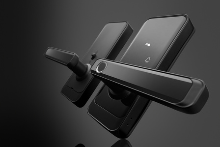 a pair of high tech door handles in black glass and matte finish on a conceptual black background photographed by leading brand photography in pune india
