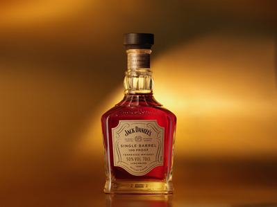 golden whiskey bottle on a golden glow background jack daniels single barrel photographed by leading whiskey photographer