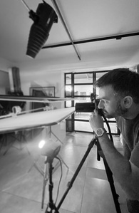 monochrome shot of best luxury product photographer shooting a cosmetic brand in his studio space in pune india