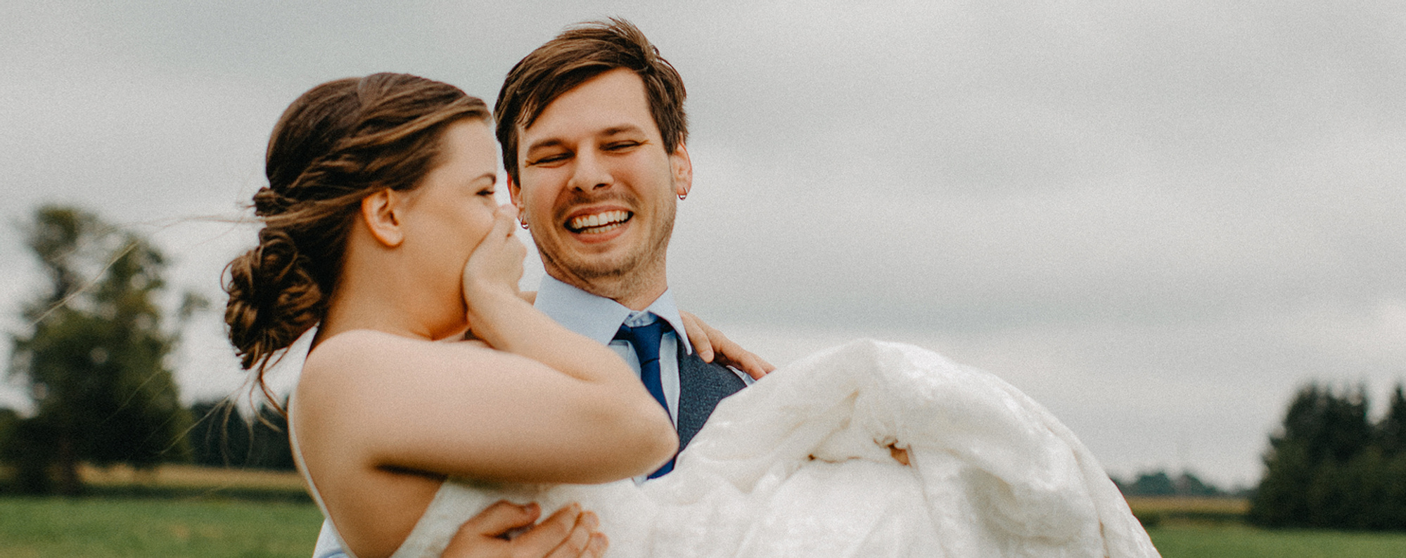 Bride getting carried after ceremony commences at Creekside Wedding Ceremony Venue in Zorra, Ontario 