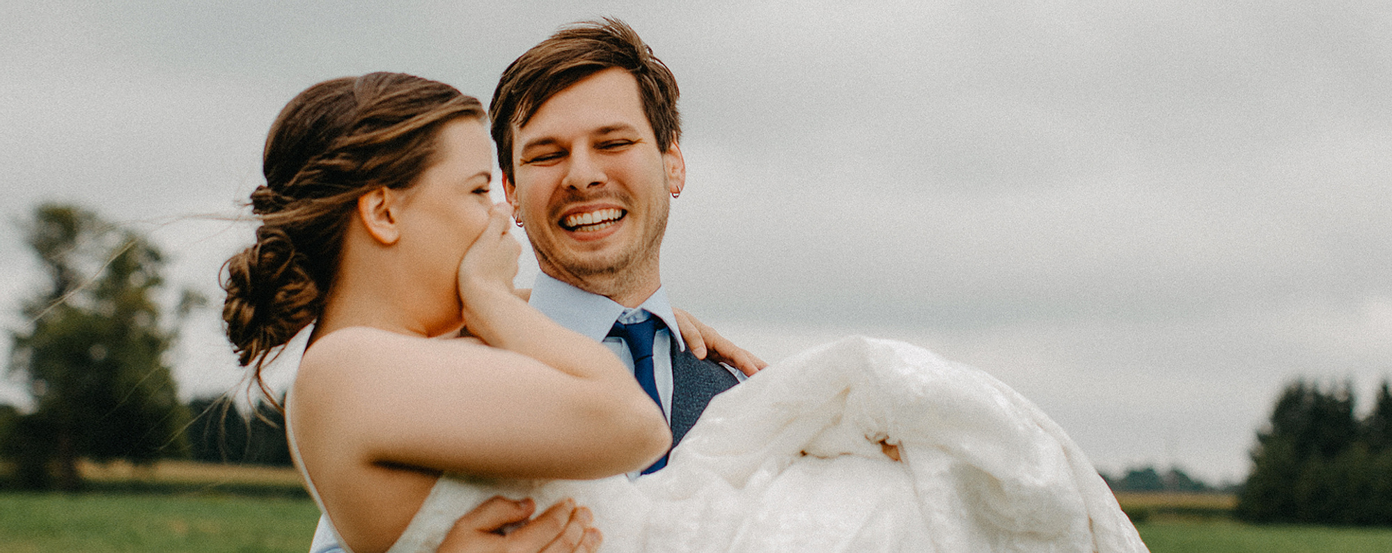 Bride getting carried after ceremony commences at Creekside Wedding Ceremony Venue in Zorra, Ontario 