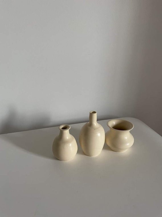 three mini vessels in off-white sit on a white table