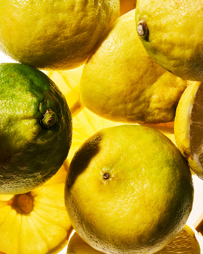 Close-up image of fresh bergamot fruits stacked on top of each other.
