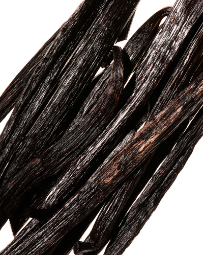 Closeup image of stacked vanilla pods.