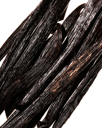Closeup image of stacked vanilla pods.