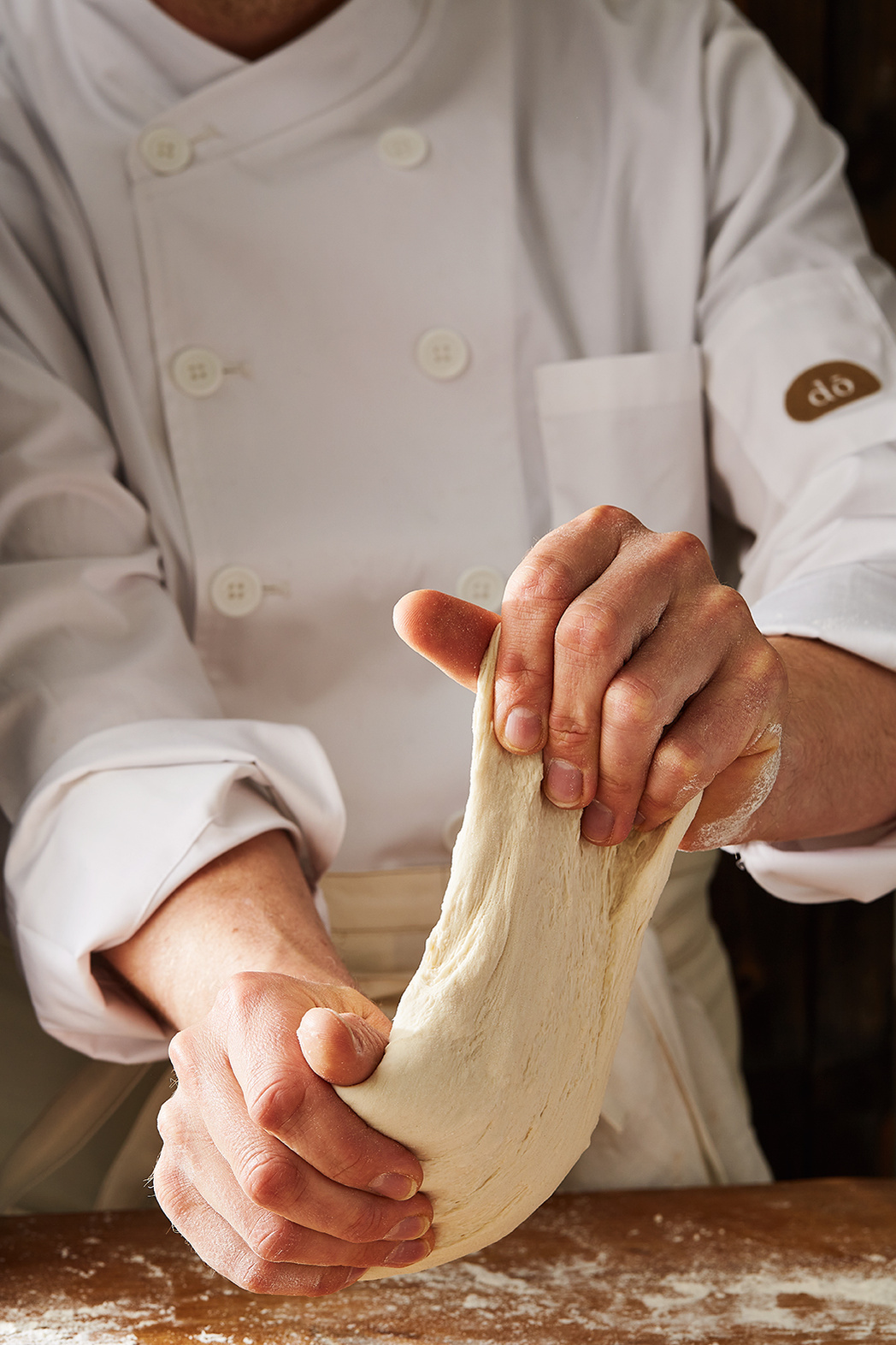 Baker stretching sourdough for Hilton in-house deli brand Do Deli. Photography by Lol Johnson. Food Prep and styling by Iona Blackshaw. Recipe development by jane Alty.