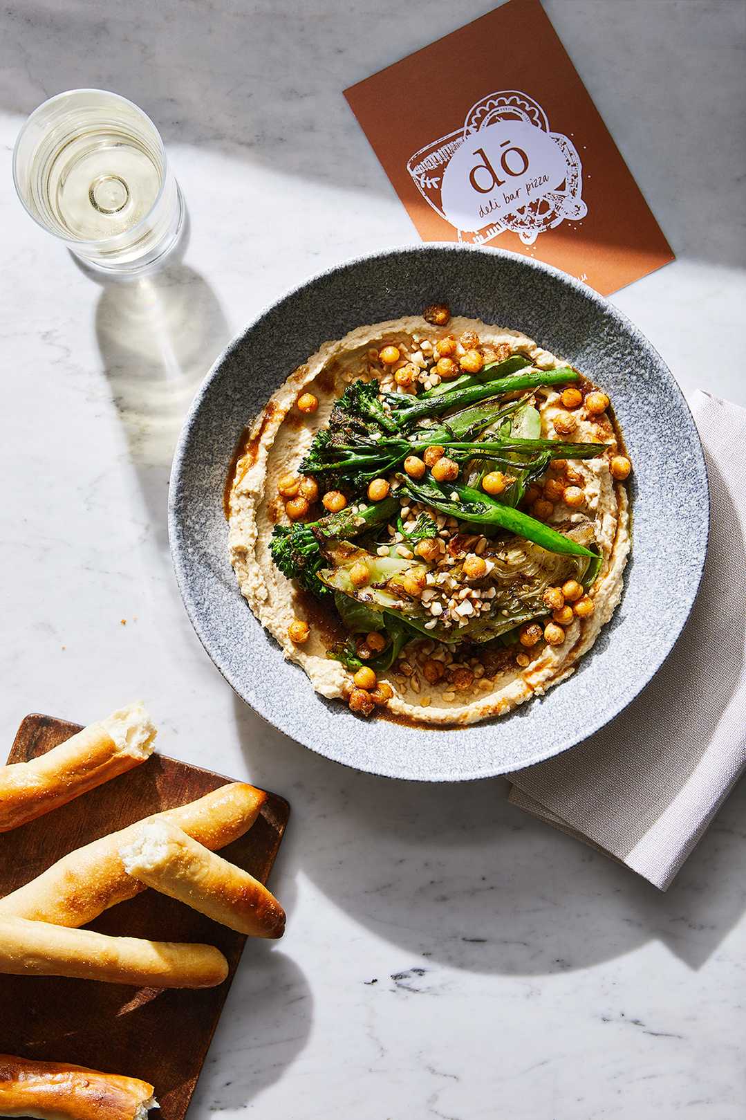 Hummus and Chickpea salad with griddled broccoli and dough sticks by Do Deli @ Hilton. Photography by south east London based food photographer Lol Johnson. Food prep and styling by Iona Blackshaw. Recipe development by consultant chef Jane Alty.