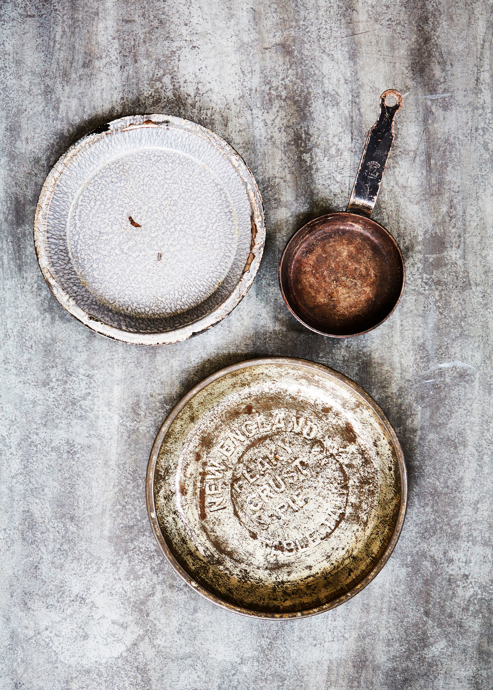 Still life imagery of rustic cookware shot against a metal surface with a patina from Topham Street props house. Shot for branding agency Seeing Things Creative by London based food and tableware photographer Lol Johnson.