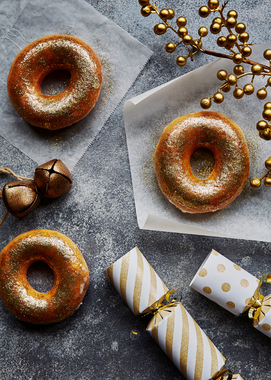 Easy ideas for food based decorating at Christmas. Gold dusted doughnuts. Shot by London based still life and food photographer Lol Johnson. Styling by Liz Cooper.