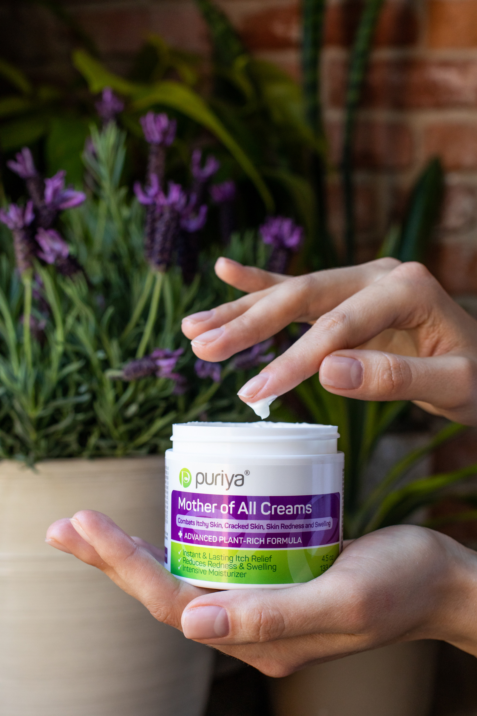 Mother of All Creams hand cream with a hand. 