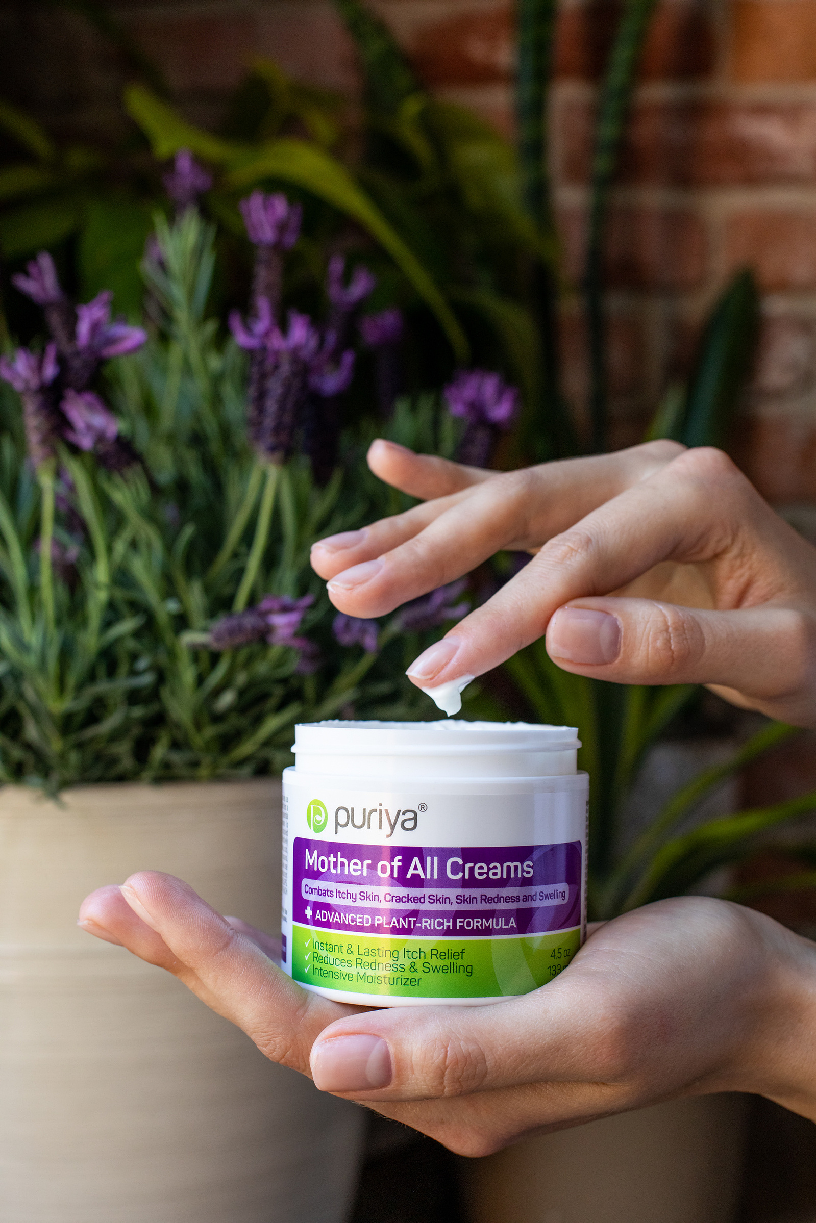 Mother of All Creams hand cream with a hand. 