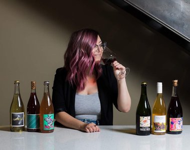A female wine writer sips a natural wine. 