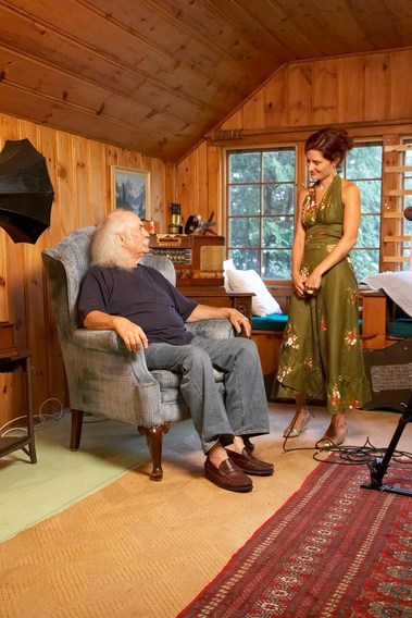 Grey hair man in arm chair looking up at woman in green dress. David Crosby and Summer Love, director of Sounds Like a Revolution. 