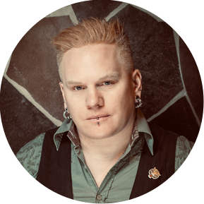 Man with spiked hair and piecings.