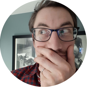 Man with his hand over his mouth looking to one side curiously.