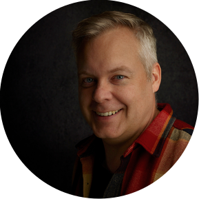 Man in plaid shirt smiling