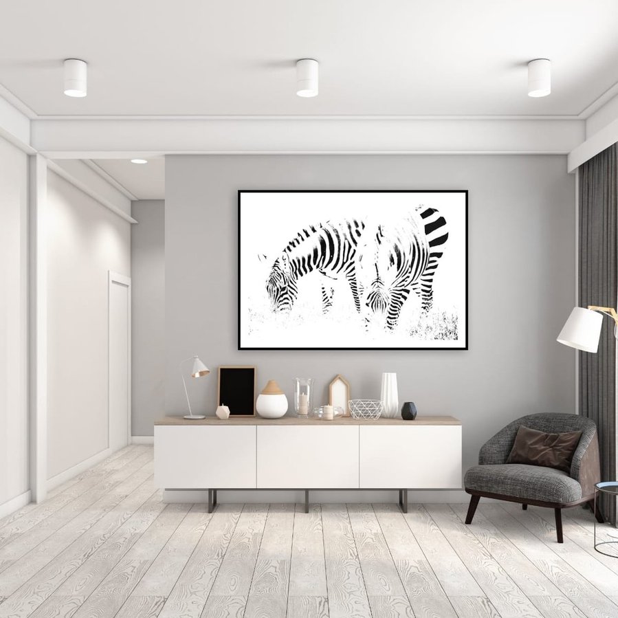 High-key black and white zebra photograph capturing two zebras grazing in perfect symmetry. A minimalist wildlife portrait focused on abstract patterns, contrast, and stillness.
